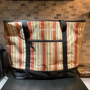 This is a KeepCool insulated cooler tote bag with a multi-colored striped patter